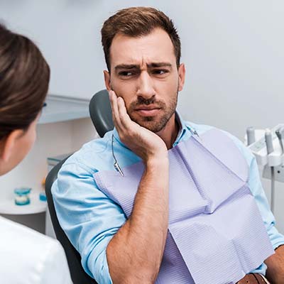Male experiencing tooth pain